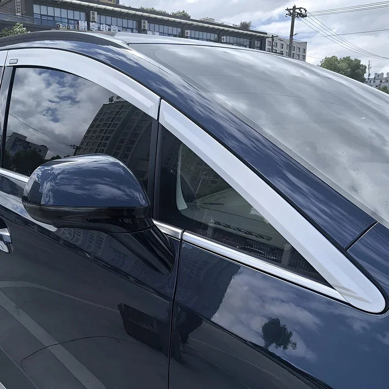 Silver chrome window trim and door frame molding on a navy blue BYD vehicle.