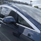 Silver chrome window trim and door frame molding on a navy blue BYD vehicle.