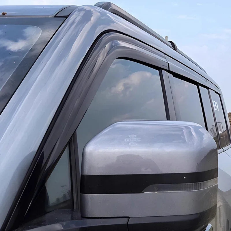 Black slim-profile window rain guards installed on a silver BYD vehicle side window.