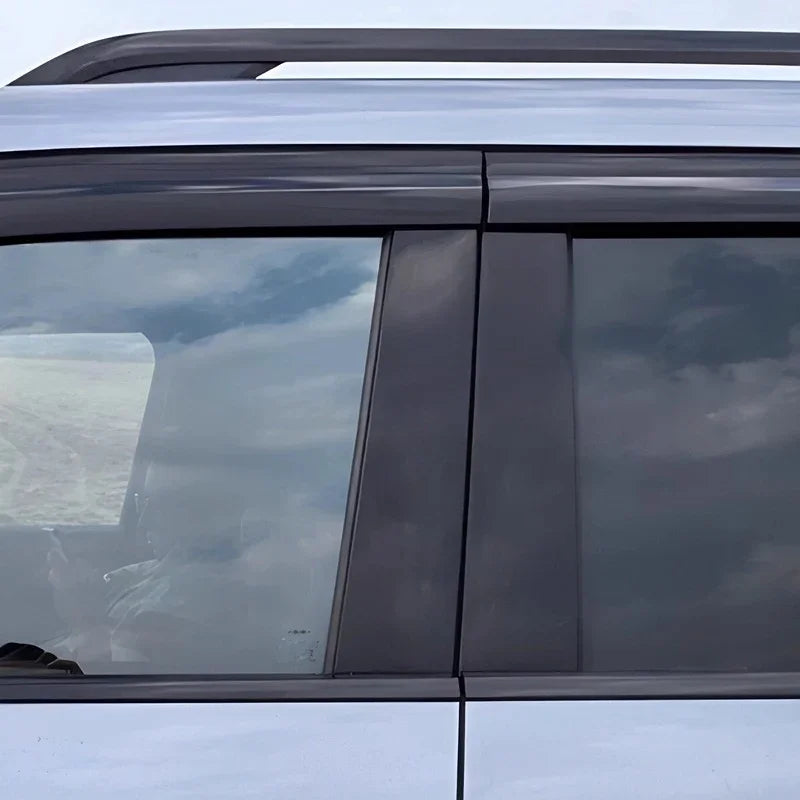 Black matte window deflectors installed on a silver BYD vehicle side window.