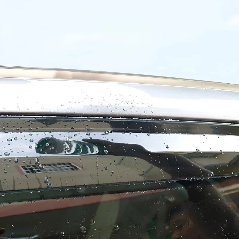 Close-up of a silver chrome car trim with hydrophobic water-beading properties.