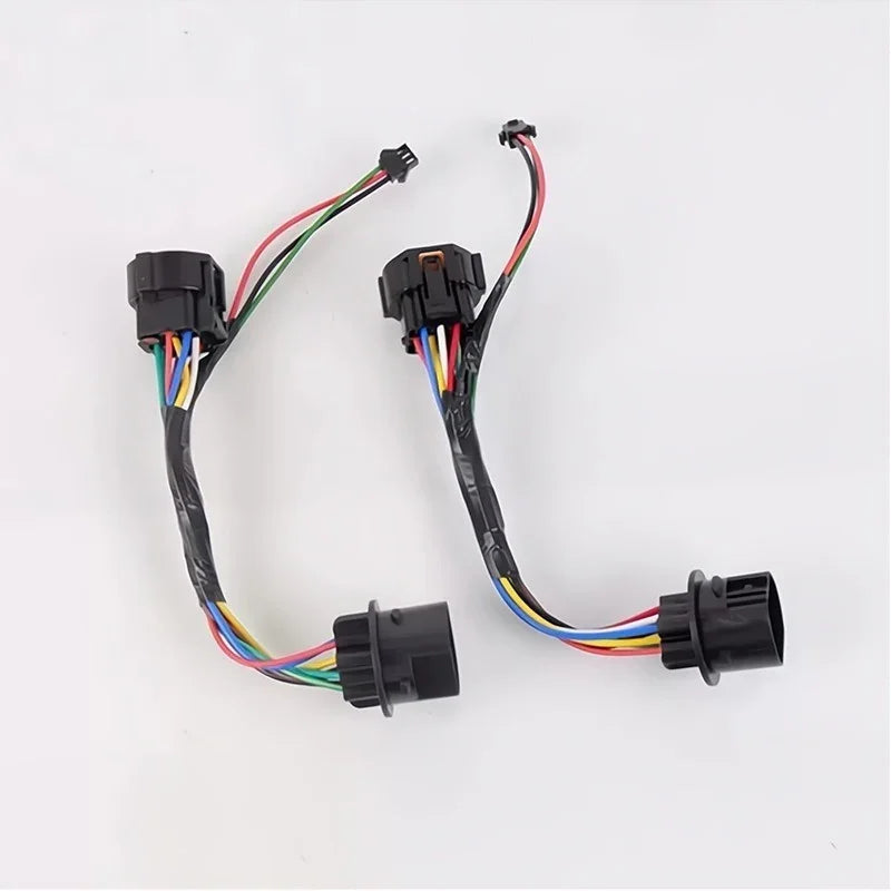 Pair of black automotive electrical wiring harnesses with multi-colored insulated wires.