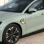 Side view of a light green BYD car featuring a yellow and black decorative fender decal.