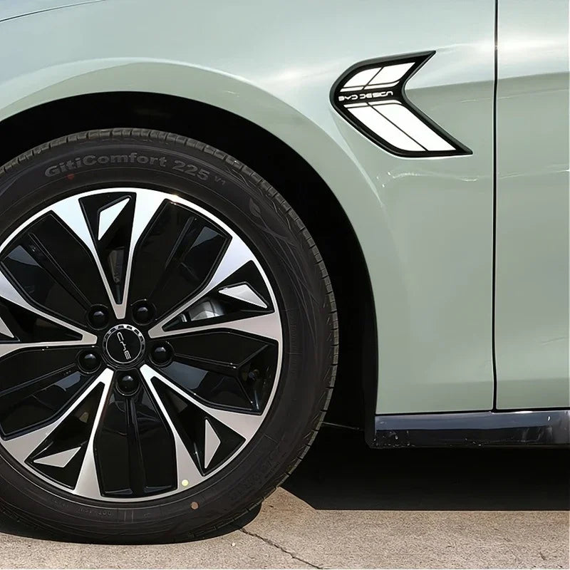 Light green BYD car featuring a sleek black and silver multi-spoke alloy wheel and side vent detail.