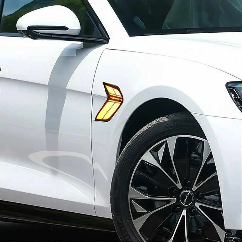 Amber LED side marker light installed on a white car fender for enhanced visibility.