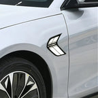 Silver car side fender featuring a sleek black and white chevron-shaped decorative emblem.