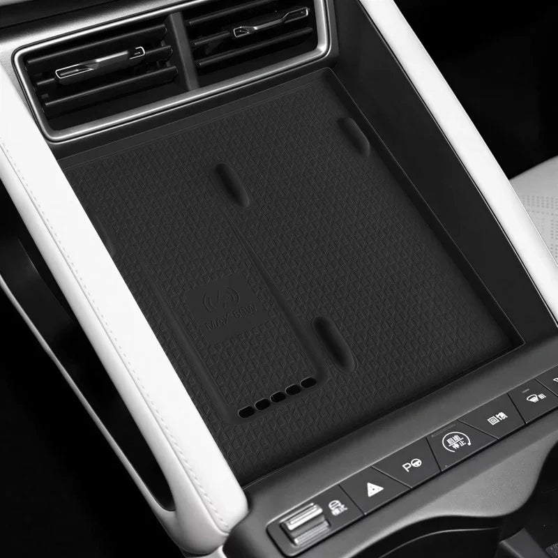 Black textured rubber center console organizer mat for car interior with wireless charging icon.