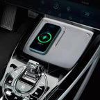 Light gray wireless charging pad with a blue smartphone charging in a BYD car interior.