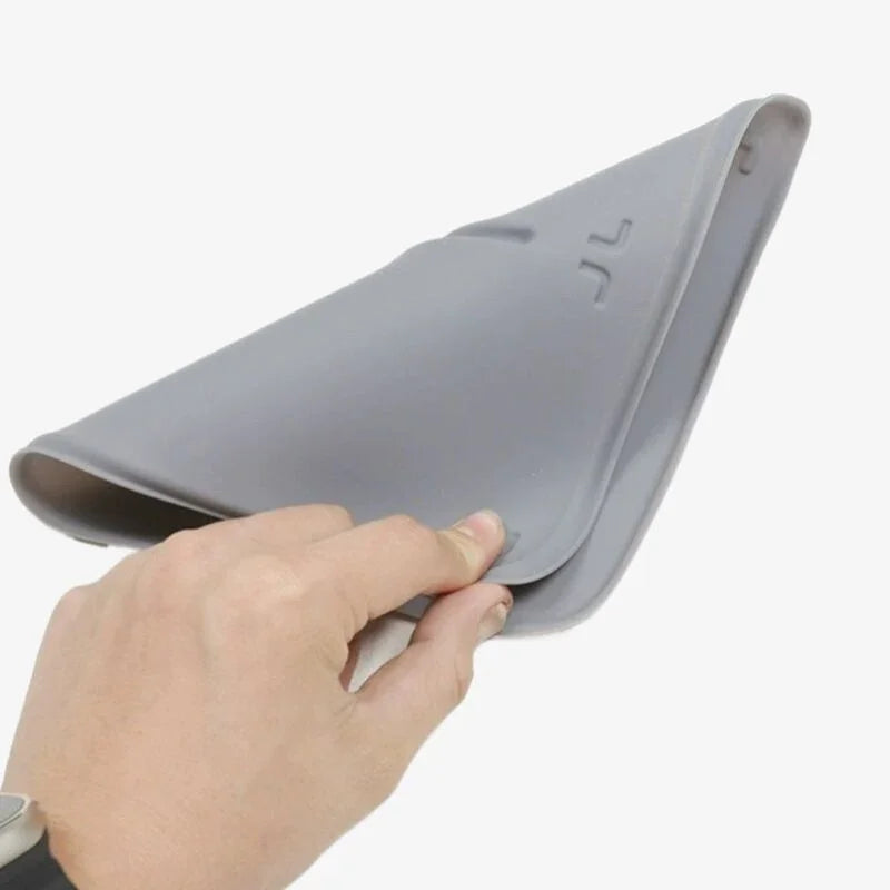 Flexible grey silicone car floor mat being bent to demonstrate durability and material flexibility.