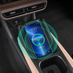 Black carbon fiber texture wireless charging pad for smartphone in car center console.