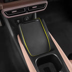 Black textured carbon fiber style center console tray with distinctive yellow edge trim.