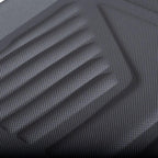 Close-up of a black textured rubber car floor mat with anti-slip ribbed patterns.