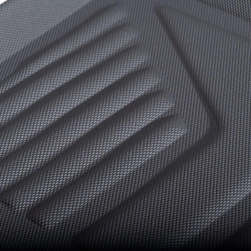 Close-up of a black textured rubber car floor mat with anti-slip ribbed patterns.