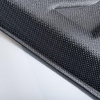 Close-up of a professional grey perforated fabric material for car interior accessories.