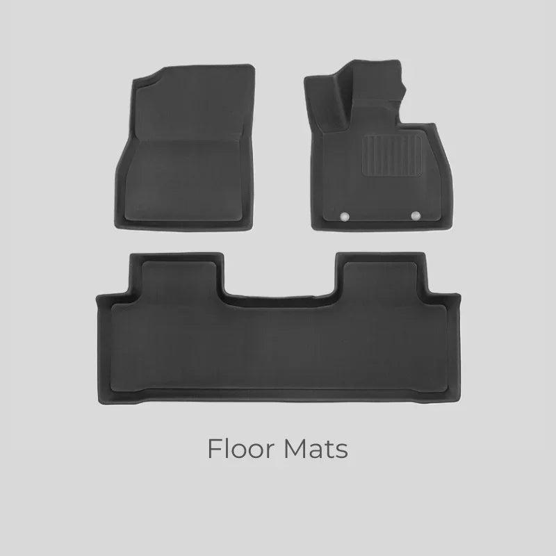 Set of premium black custom-fit car floor mats made of durable, high-quality fabric material.