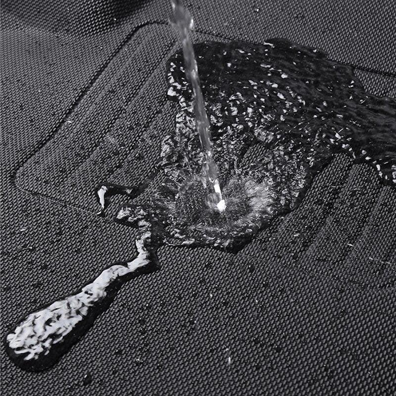 Water repelling black textured waterproof car floor mat showing liquid resistance.