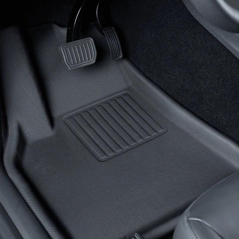 Black textured TPE car floor mat protecting the vehicle footwell area.