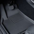 Black textured TPE car floor mat protecting the vehicle footwell area.