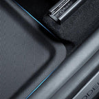 Black textured waterproof car floor mat with premium blue edge stitching.