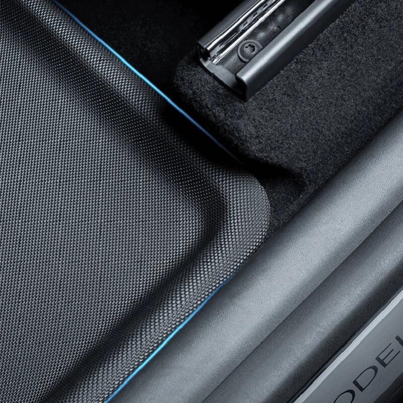 Black textured waterproof car floor mat with premium blue edge stitching.