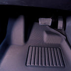 Custom-fit black textured car floor mat with durable ribbed heel pads for wear protection.
