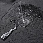 Water repelling black waterproof texture of a durable car floor mat surface.