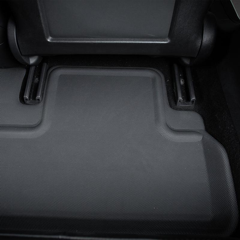 Close-up of black textured synthetic leather car floor mats for interior protection.