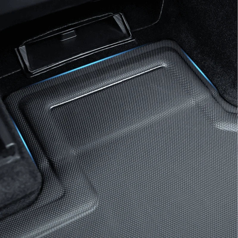 Black carbon fiber textured car floor mat with blue accent lighting