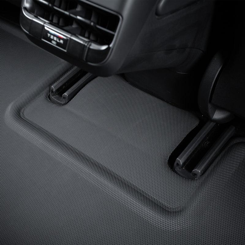 Black textured TPE all-weather floor mat with custom-fit raised edges for vehicle protection.