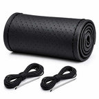 Black perforated leather steering wheel cover roll with stitching thread kit on white background