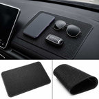 Black anti-slip dashboard mat inside a BYD car holding smartphone, sunglasses, and car key securely