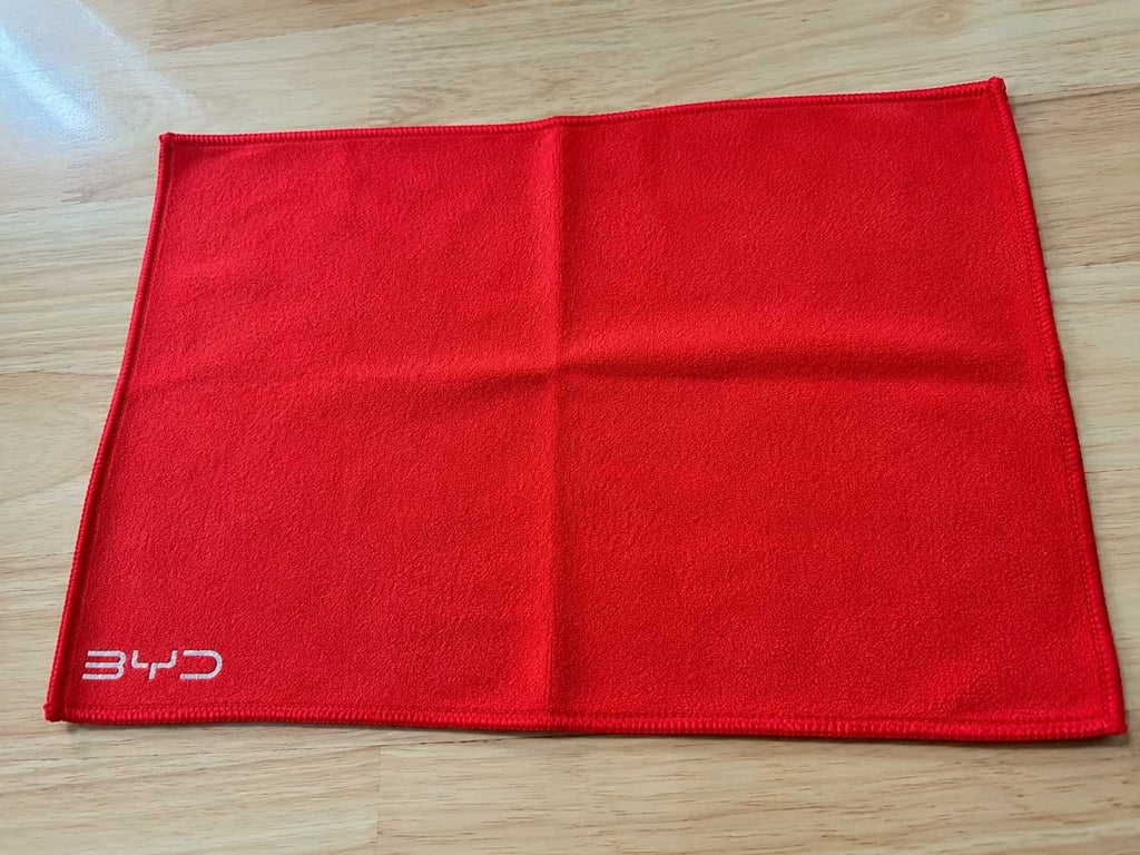 Red BYD microfiber car wash and drying towel made from coral velvet fabric, 295x195mm reusable cleaning cloth for vehicle detailing and interior care.