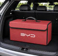 Red BYD foldable trunk storage organizer box placed inside a vehicle cargo area for organized storage and travel essentials