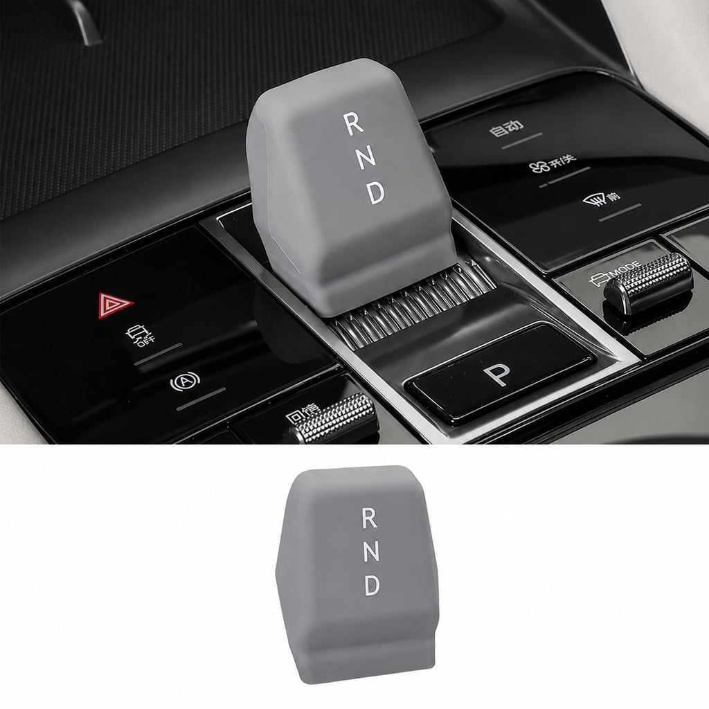 Car gear shift lever with 'RND' marking, shown in a car interior setting.