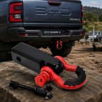 Red and black trailer tow hook connector installed on BYD Shark 6 rear towing hitch outdoors