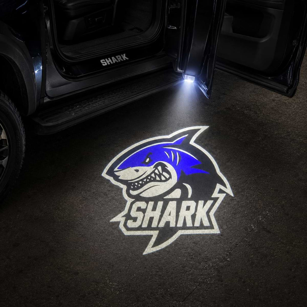 Blue Shark logo LED welcome light projection beside BYD Shark vehicle at night
