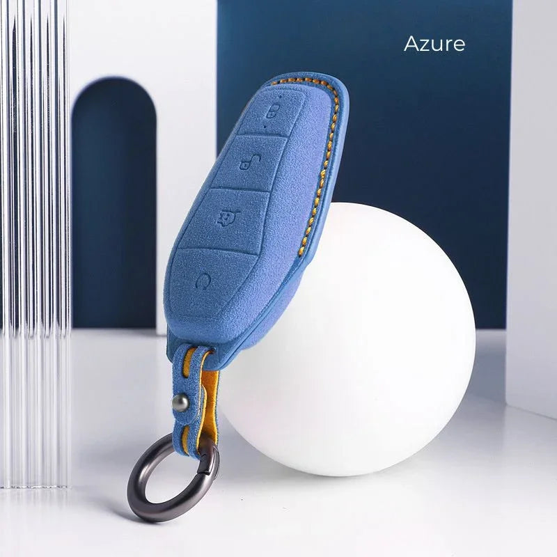 Azure blue leather car key case with yellow stitching and metal keyring