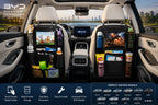 Universal car backseat organizer with touch screen tablet holder installed in a BYD vehicle interior, featuring multiple storage pockets for drinks, toys, snacks, and travel essentials.